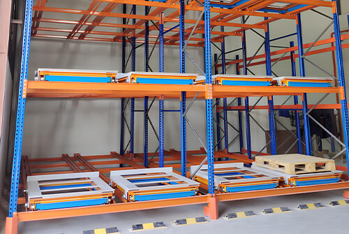 Cart push back racking system with pallet roller tracks in warehouse