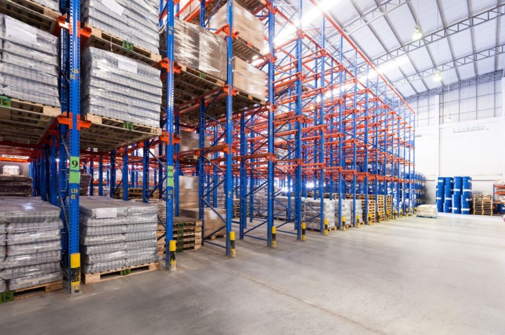 Drive-in racking system warehouse with tall pallet racks and palletized goods