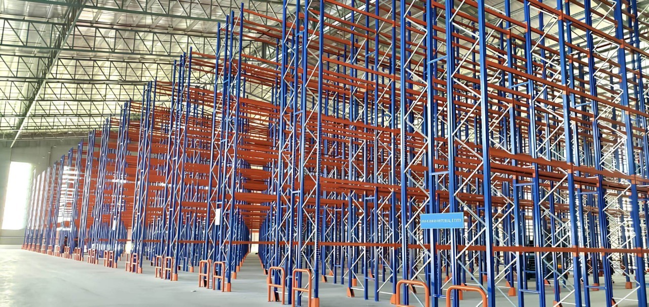 Selective pallet racking system in warehouse with tall blue and orange racks