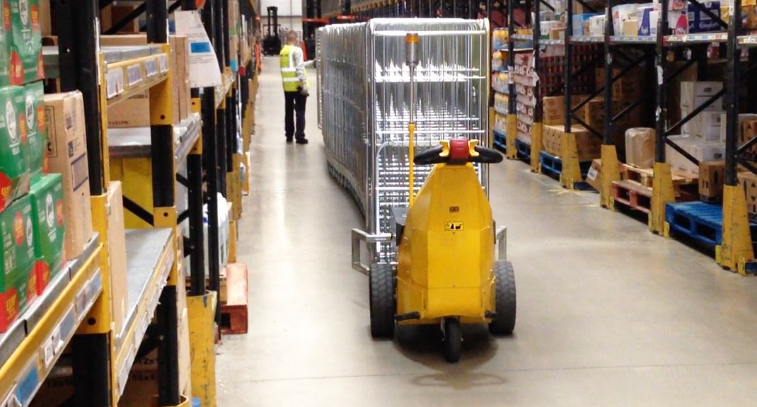 MasterMover electric tug moving heavy wheeled loads in a logistics or warehousing environment